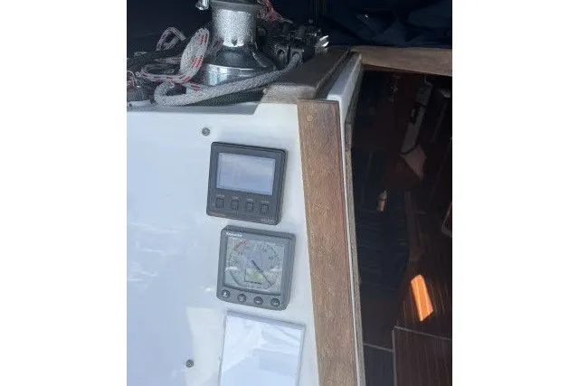 Slide: The Image of Cockpit instruments on a 1990 Catalina 42 sailboat, featuring navigation displays and winch. - 21