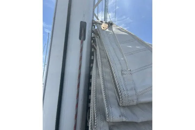Slide: The Image of Sail of a 1990 Catalina 42 yacht against a clear blue sky. - 36
