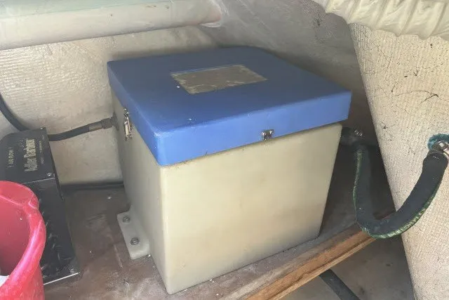 Slide: The Image of Battery box in a 1990 Catalina 42 sailboat, secured with a blue lid. - 31