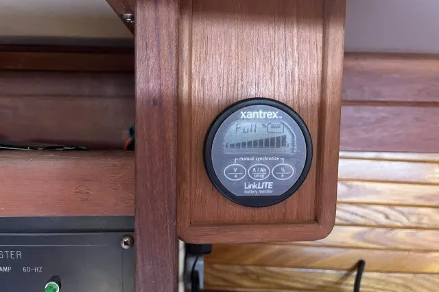 Slide: The Image of Xantrex LinkLITE battery monitor in a 1990 Catalina 42 yacht, displaying full charge. - 10