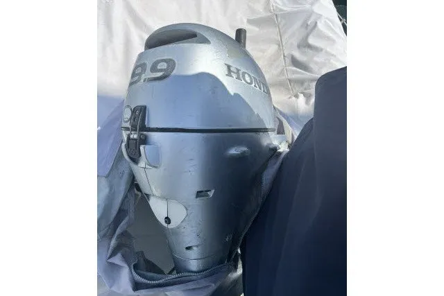Slide: The Image of Silver Honda 2.9 outboard motor on a 1990 Catalina 42 sailboat. - 43