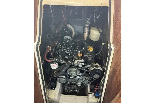 Slide: The Image of Engine compartment of a 1990 Catalina 42 sailboat, showcasing mechanical components. - 44