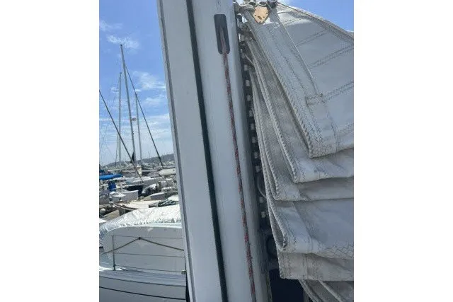 Slide: The Image of Folded sail on a 1990 Catalina 42 yacht, docked at a marina. - 37