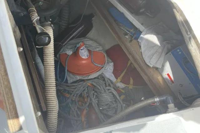 Slide: The Image of Storage compartment of a 1990 Catalina 42 sailboat with ropes and equipment. - 30