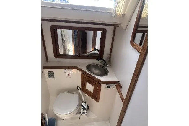 Slide: The Image of Bathroom interior of a 1990 Catalina 42 sailboat with sink and toilet. - 19