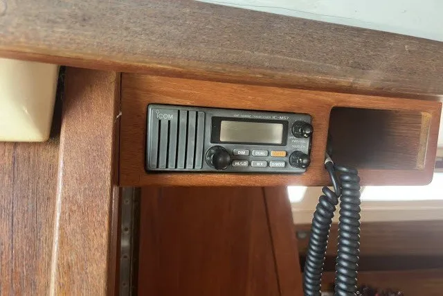 Slide: The Image of VHF radio installed in a 1990 Catalina 42 sailboat's wooden cabin interior. - 11