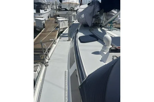 Slide: The Image of 1990 Catalina 42 sailboat docked, showcasing deck and rigging details. - 33