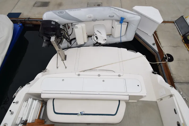 Slide: The Image of 2005 Sea Ray 500 Sedan Bridge with dinghy and outboard motor at dock. - 37