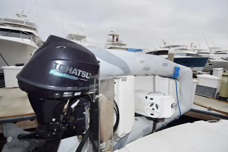 Slide: The Image of Inflatable boat with Tohatsu outboard motor docked near Sea Ray 500 Sedan Bridge, 2005 model. - 34