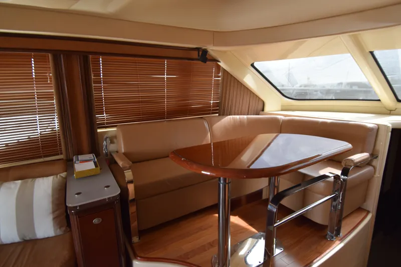 Slide: The Image of Luxurious interior of 2005 Sea Ray 500 Sedan Bridge yacht with elegant seating and table. - 4