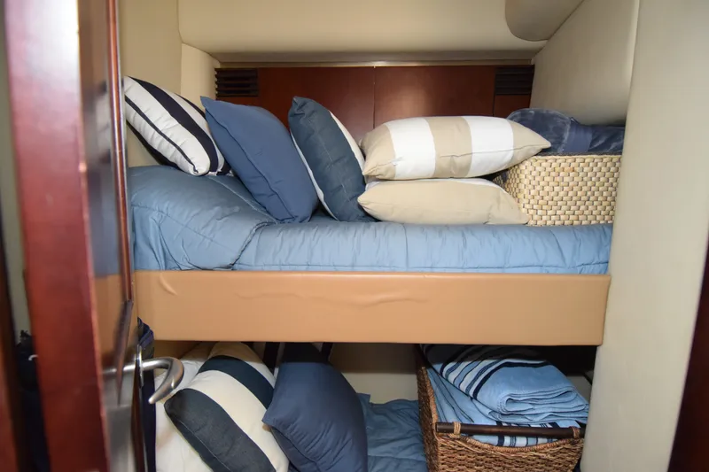Slide: The Image of Cozy cabin interior of 2005 Sea Ray 500 Sedan Bridge with neatly arranged bedding. - 15