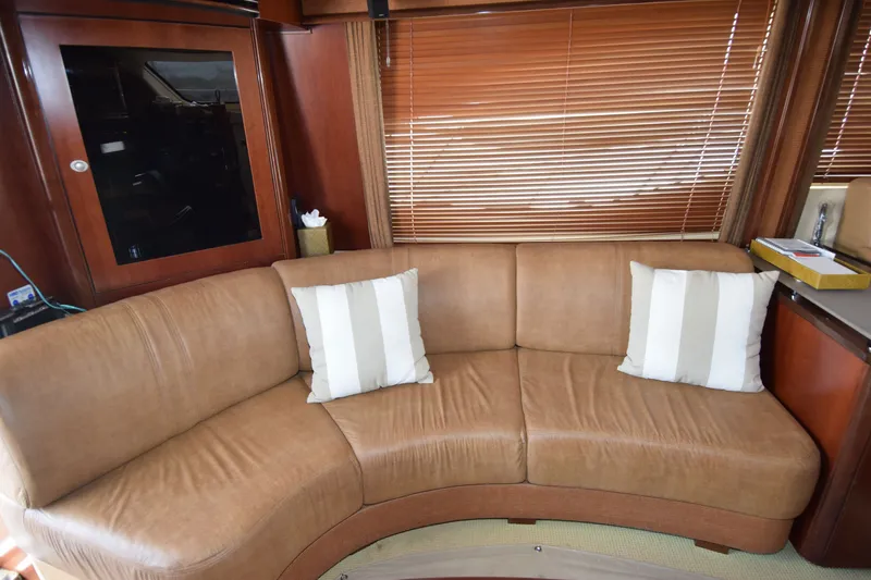 Slide: The Image of Luxurious interior of 2005 Sea Ray 500 Sedan Bridge with curved leather sofa and striped cushions. - 3