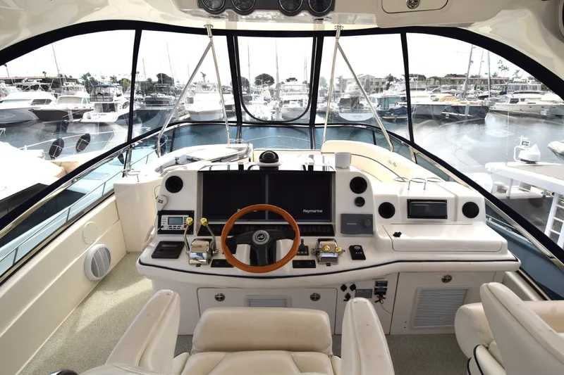 Slide: The Image of Helm of 2005 Sea Ray 500 Sedan Bridge yacht with marina view. - 17