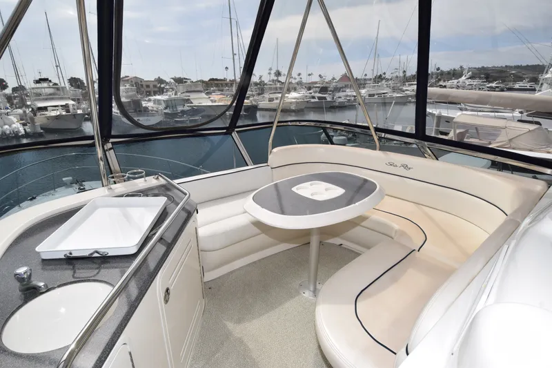 Slide: The Image of 2005 Sea Ray 500 Sedan Bridge yacht interior with seating and marina view. - 18