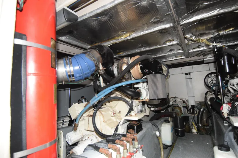 Slide: The Image of Engine room of a 2005 Sea Ray 500 Sedan Bridge yacht, showcasing mechanical components. - 31