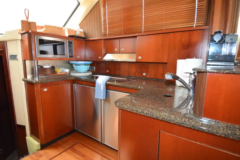 Slide: The Image of Luxurious kitchen interior of 2005 Sea Ray 500 Sedan Bridge yacht with wood cabinetry. - 7