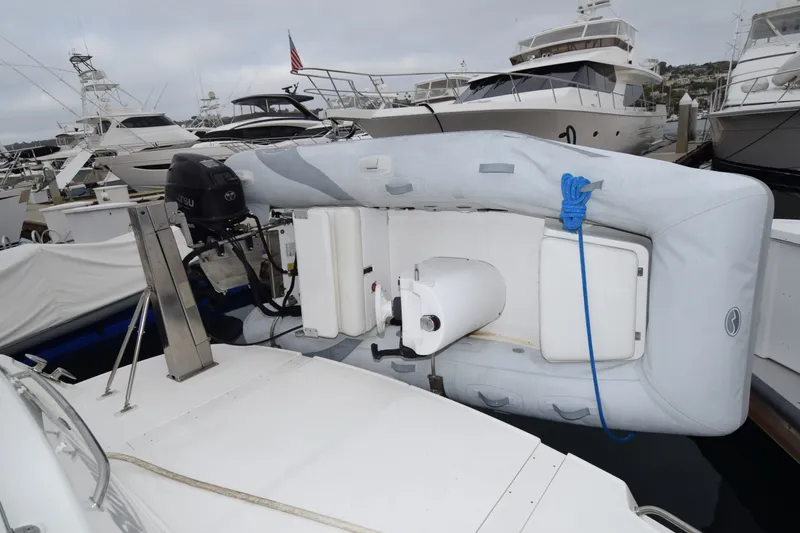 Slide: The Image of 2005 Sea Ray 500 Sedan Bridge with inflatable dinghy and outboard motor at marina. - 33