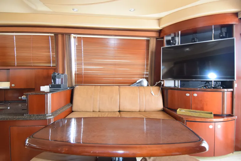 Slide: The Image of Luxurious interior of 2005 Sea Ray 500 Sedan Bridge yacht with leather seating and TV. - 6