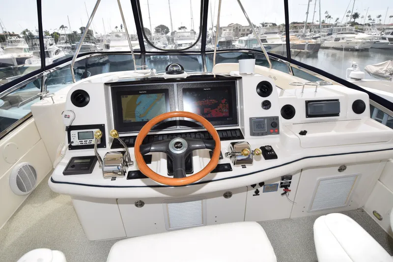 Slide: The Image of Helm of 2005 Sea Ray 500 Sedan Bridge with navigation screens and controls. - 19