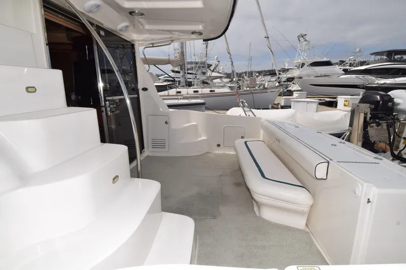 Slide: The Image of 2005 Sea Ray 500 Sedan Bridge yacht interior with seating and stairs at marina. - 26