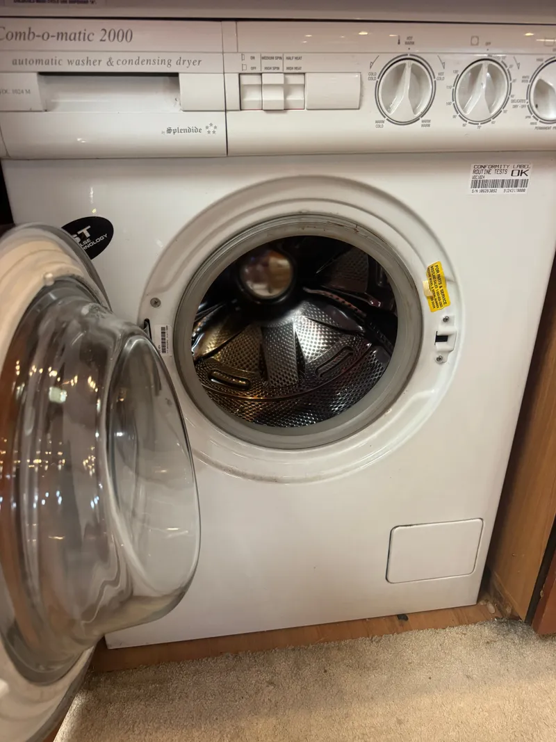 Slide: The Image of Washing machine in a boat cabin, with an open door and controls on top. - 29