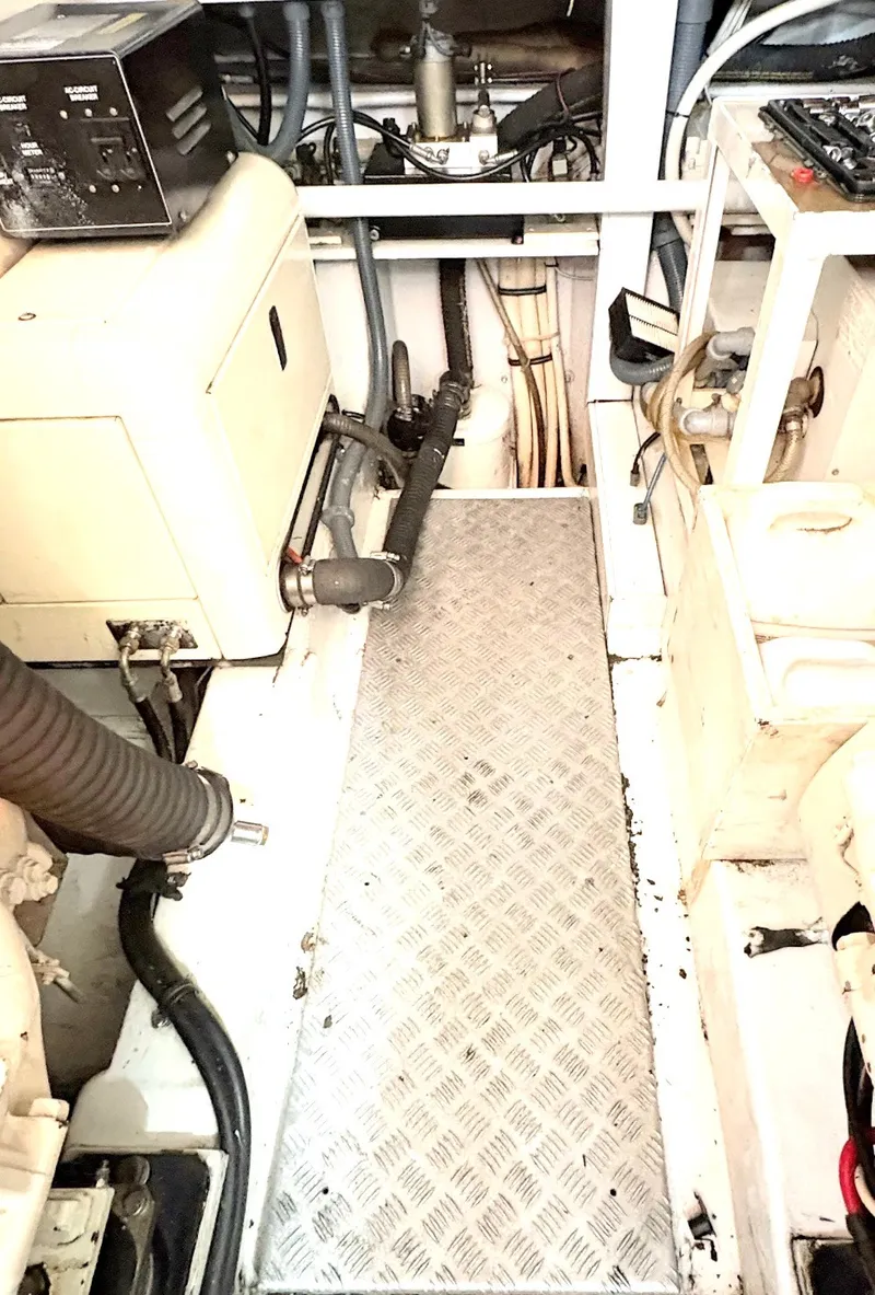 Slide: The Image of The engine room of a 2000 Sunseeker Predator 56 with technical equipment and piping. - 38