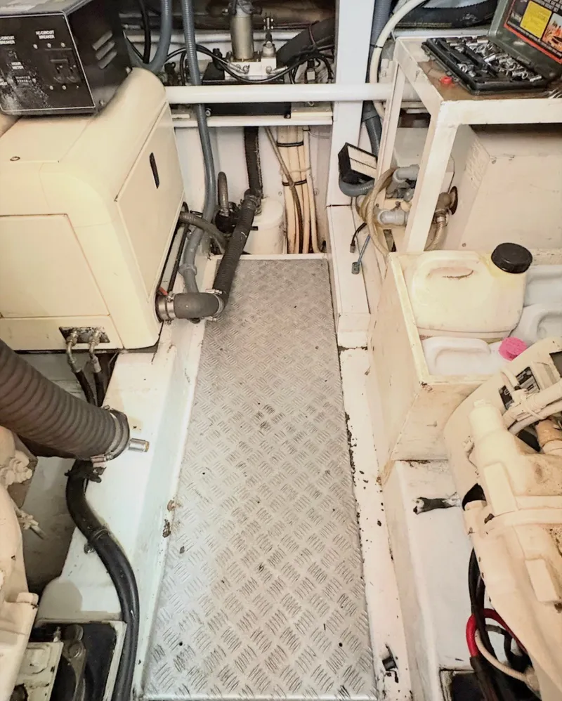 Slide: The Image of The engine room of a 2000 Sunseeker Predator 56 with various technical components. - 36