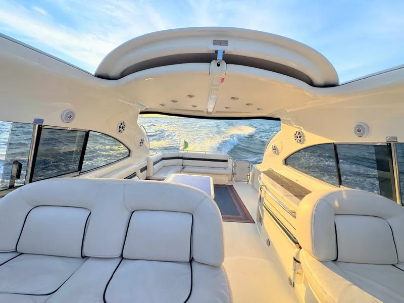 Slide: The Image of The image shows the luxurious cockpit of a 2000 Sunseeker Predator 56 on the water. - 13