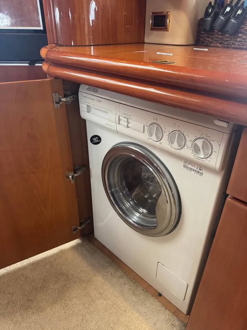 Slide: The Image of A washing machine is built into a wooden cabinet, surrounded by polished wood surfaces. - 30