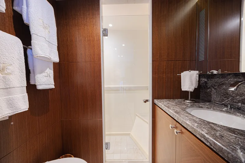 Slide: The Image of Luxurious bathroom on 2016 Ocean Alexander 100 Skylounge Megayacht with elegant wood paneling. - 39