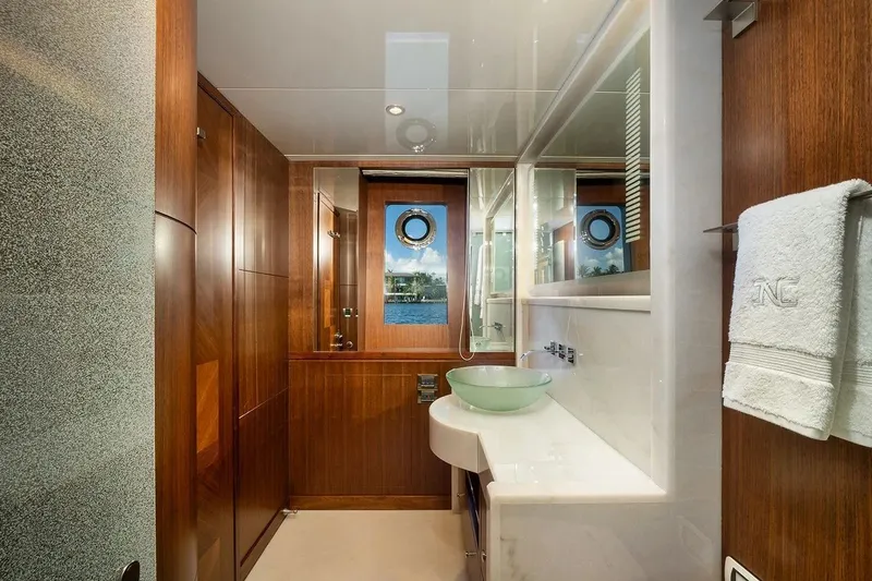 Slide: The Image of Luxurious bathroom on 2016 Ocean Alexander 100 Skylounge Megayacht with wood accents and glass sink. - 27