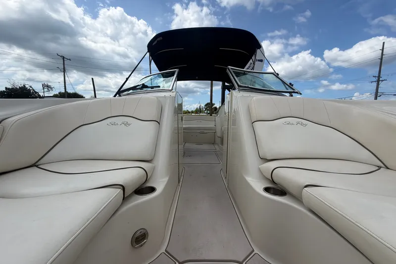 Slide: The Image of 2008 Sea Ray 240 Sundeck interior with white seating under a blue sky. - 71