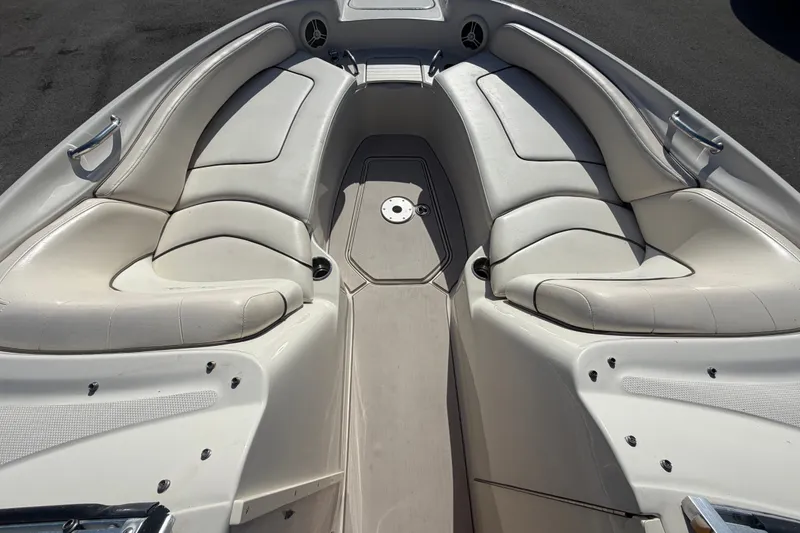 Slide: The Image of 2008 Sea Ray 240 Sundeck boat interior with white cushioned seating and sleek design. - 52