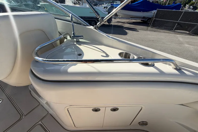 Slide: The Image of 2008 Sea Ray 240 Sundeck interior with seating and stainless steel railings. - 23