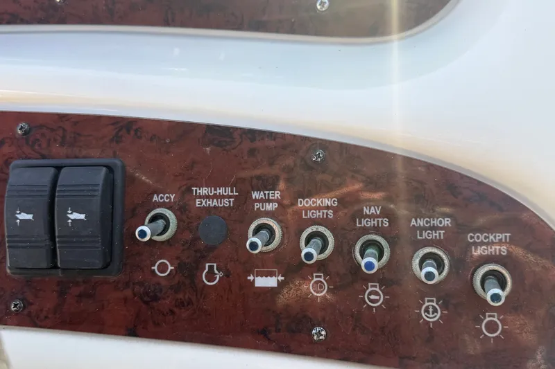 Slide: The Image of Control panel of a 2008 Sea Ray 240 Sundeck boat with various switches. - 45
