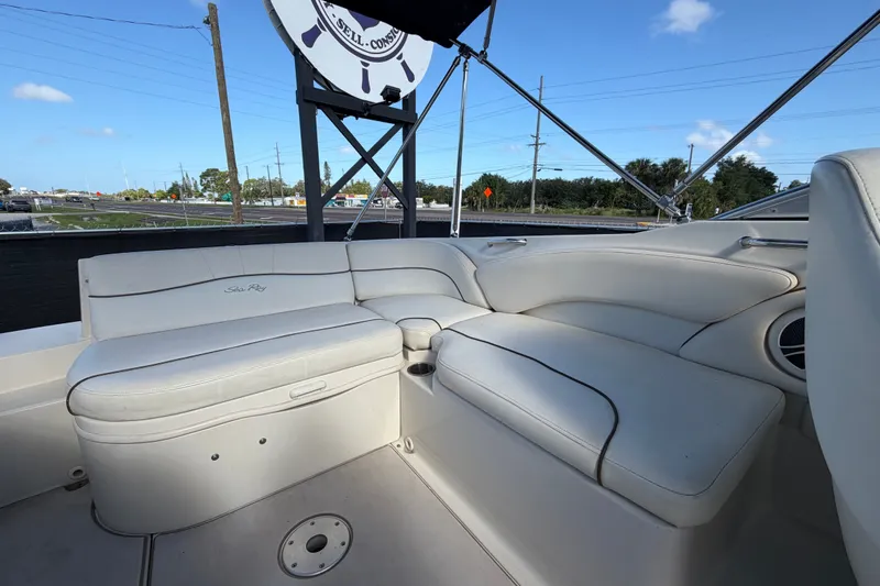 Slide: The Image of 2008 Sea Ray 240 Sundeck boat interior with white seating and cup holders. - 74