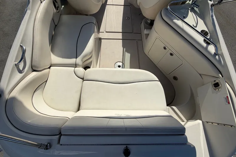 Slide: The Image of Interior view of a 2008 Sea Ray 240 Sundeck boat with white seating and storage compartments. - 22