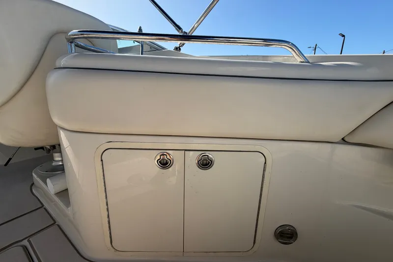 Slide: The Image of 2008 Sea Ray 240 Sundeck interior detail with storage compartment and seating. - 25