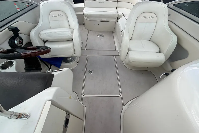 Slide: The Image of Interior of a 2008 Sea Ray 240 Sundeck boat with white seating and steering wheel. - 72