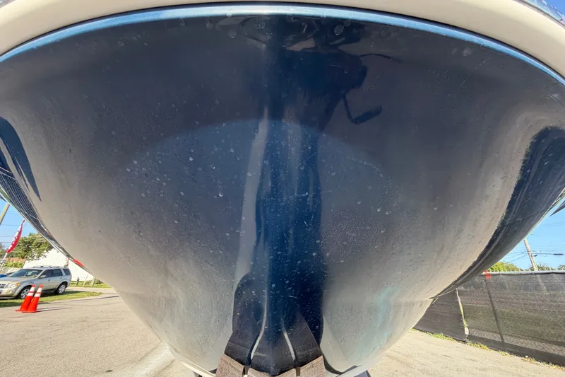 Slide: The Image of 2008 Sea Ray 240 Sundeck boat hull, close-up view, parked outdoors. - 13