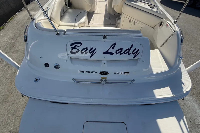 Slide: The Image of 2008 Sea Ray 240 Sundeck boat named "Bay Lady" with white seating and deck. - 16