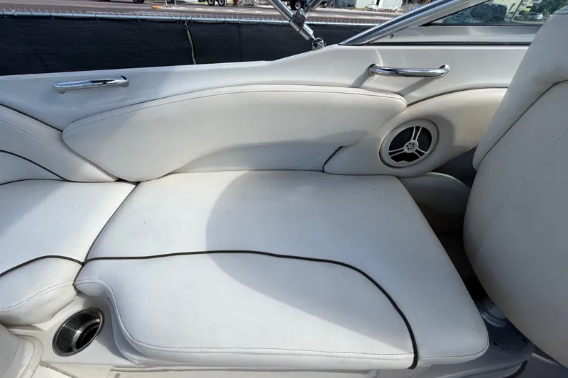 Slide: The Image of White leather seating on a 2008 Sea Ray 240 Sundeck boat interior. - 75