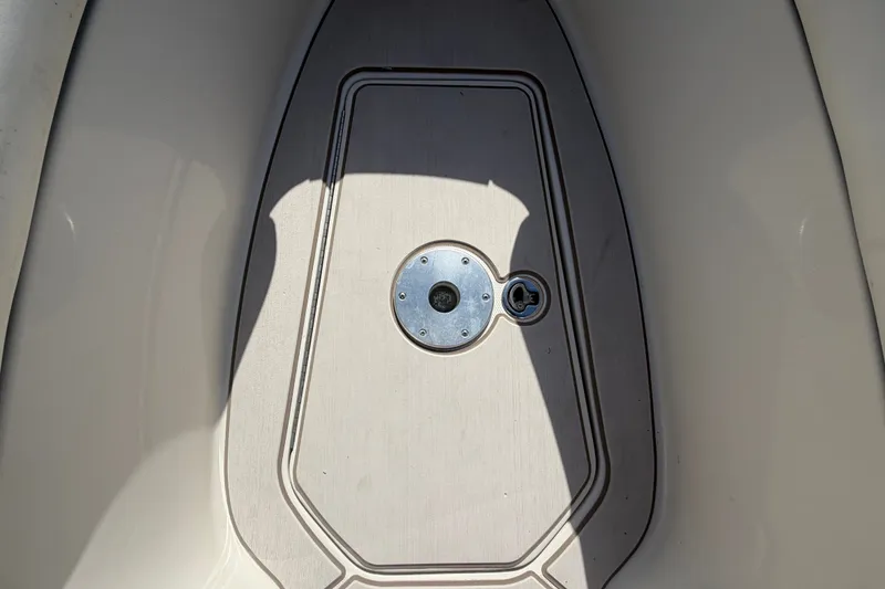 Slide: The Image of 2008 Sea Ray 240 Sundeck deck hatch with metal fittings in sunlight. - 55