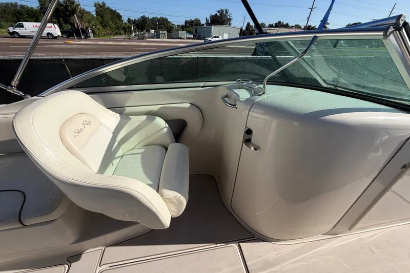 Slide: The Image of 2008 Sea Ray 240 Sundeck interior with white seating and windshield. - 33