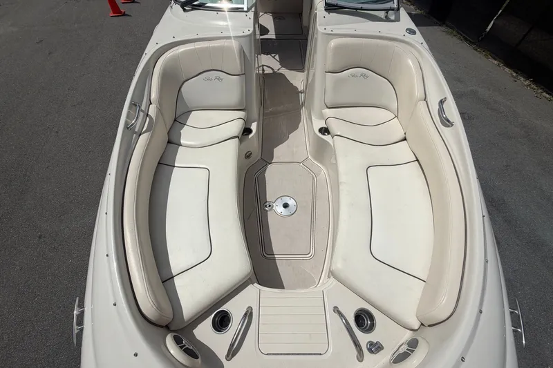 Slide: The Image of The image shows the cockpit of a 2008 Sea Ray 240 Sundeck with beige seating. - 68