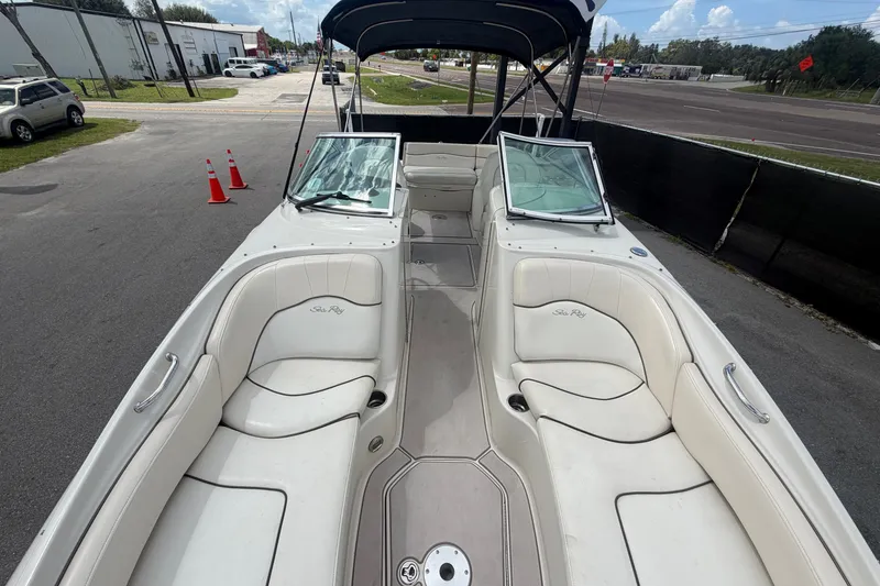 Slide: The Image of 2008 Sea Ray 240 Sundeck boat with white seating and open deck layout. - 69