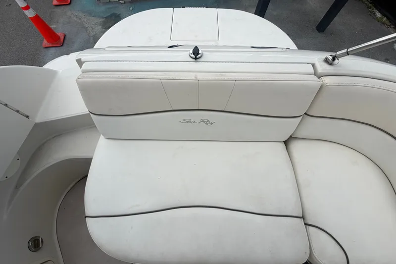 Slide: The Image of 2008 Sea Ray 240 Sundeck boat seating area with white upholstery. - 81