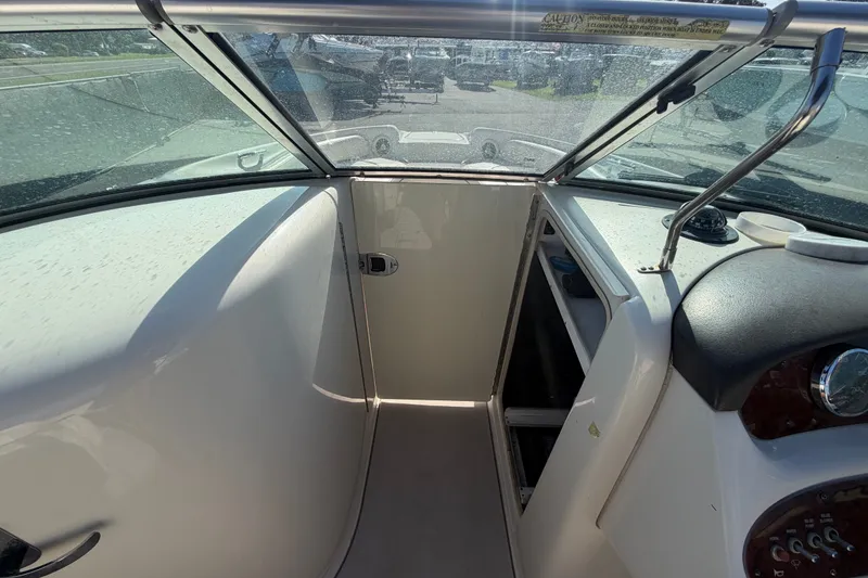 Slide: The Image of Interior view of a 2008 Sea Ray 240 Sundeck boat, featuring a windshield and dashboard. - 51