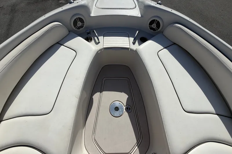 Slide: The Image of 2008 Sea Ray 240 Sundeck boat interior with cushioned seating and speakers. - 54