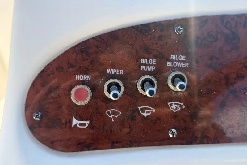 Slide: The Image of Control panel of a 2008 Sea Ray 240 Sundeck with switches for horn, wiper, bilge pump, and blower. - 43
